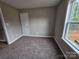 Bedroom features plush carpet, neutral walls, a window and a door at 3667 Travertine Dr, Lancaster, SC 29720