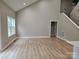 Open-concept living room with high ceilings, large window, and stairs to the upper level at 3667 Travertine Dr, Lancaster, SC 29720