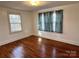 Bright bedroom featuring hardwood floors, natural light from windows, and fresh paint throughout at 3672 Nc Hwy 127 Hwy, Hickory, NC 28602