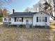 Charming single-story home with white siding, black shutters, and a cozy front porch with a chimney at 3672 Nc Hwy 127 Hwy, Hickory, NC 28602