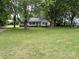 A single-story home surrounded by mature trees, offering a peaceful and shaded setting at 3672 Nc Hwy 127 Hwy, Hickory, NC 28602
