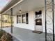 Close-up of front porch with black iron railings, exterior light fixture, storm door, and updated house number at 3672 Nc Hwy 127 Hwy, Hickory, NC 28602