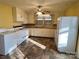 Bright kitchen with white appliances, wooden countertops, neutral tile floors, and a vintage ceiling fan at 3672 Nc Hwy 127 Hwy, Hickory, NC 28602