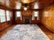 Inviting living room with wood-paneled walls, fireplace, hardwood floors, ceiling fan, and plenty of sunlight at 3672 Nc Hwy 127 Hwy, Hickory, NC 28602