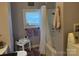 Functional bathroom with a sink, toilet, bathtub, and washing machine, perfect for daily needs at 412 E Ross Grove Rd, Shelby, NC 28150