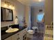 Functional bathroom with a sink, toilet, bathtub, and washing machine, perfect for daily needs at 412 E Ross Grove Rd, Shelby, NC 28150
