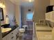 Functional bathroom with a sink, toilet, bathtub, and washing machine, perfect for daily needs at 412 E Ross Grove Rd, Shelby, NC 28150