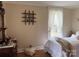 Inviting bedroom with a classic dresser, soft lighting, and a cozy bed, creating a serene retreat at 412 E Ross Grove Rd, Shelby, NC 28150