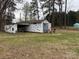 Exterior view of a shed on property, with license plates decorating the siding at 412 E Ross Grove Rd, Shelby, NC 28150