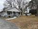 Charming single story home featuring a covered porch, well-kept lawn, and detached garage at 412 E Ross Grove Rd, Shelby, NC 28150