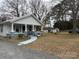 Charming single story home featuring a covered porch, well-kept lawn, and detached garage at 412 E Ross Grove Rd, Shelby, NC 28150