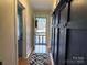 Inviting hallway featuring a decorative rug, coat hooks, and a view of the front door at 412 E Ross Grove Rd, Shelby, NC 28150