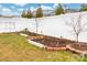 Backyard featuring a privacy fence, landscaped garden beds, and green grass at 4427 Allenby Pl, Monroe, NC 28110