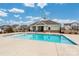 Community pool surrounded by a concrete deck and fence, with houses in the background at 4427 Allenby Pl, Monroe, NC 28110