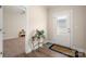 Bright entryway featuring wood floors and view into adjacent carpeted room at 4427 Allenby Pl, Monroe, NC 28110