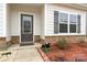 Close-up of a home entrance, showcasing decorative stone and gray shutters at 4427 Allenby Pl, Monroe, NC 28110