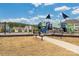 Community playground with slides, climbing structures, and benches for relaxing at 4427 Allenby Pl, Monroe, NC 28110