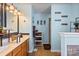 Bright bathroom with a double vanity, and decorative wall hangings at 4710 Nijinsky Ct, Charlotte, NC 28216