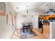 Open dining room with modern light fixture, table, and view of the open concept kitchen at 4710 Nijinsky Ct, Charlotte, NC 28216