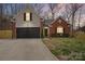 Charming home featuring a brick and siding exterior, an attached garage, and a well-manicured lawn at 4710 Nijinsky Ct, Charlotte, NC 28216
