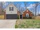 Charming home featuring a brick and siding exterior, an attached garage, and a well-manicured lawn at 4710 Nijinsky Ct, Charlotte, NC 28216
