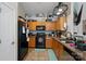 Functional kitchen with wood cabinets, black appliances, and ample countertop space at 4710 Nijinsky Ct, Charlotte, NC 28216