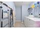 Functional laundry room with washer, dryer, and storage shelves for convenience at 4710 Nijinsky Ct, Charlotte, NC 28216