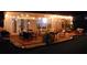 An inviting outdoor patio with stylish seating, illuminated by ambient string lights at night at 4710 Nijinsky Ct, Charlotte, NC 28216