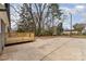 The backyard is lush and private, with mature trees, a wooden deck and a large concrete patio at 510 Colony Acres Dr, Charlotte, NC 28217