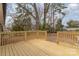 The backyard is lush and private, with mature trees and a wooden deck at 510 Colony Acres Dr, Charlotte, NC 28217