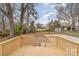 The backyard is lush and private, with mature trees and a wooden deck at 510 Colony Acres Dr, Charlotte, NC 28217