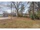 The backyard is lush and private, with mature trees, and a view of the back of the home at 510 Colony Acres Dr, Charlotte, NC 28217