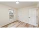 This bedroom has neutral walls and flooring, with natural light, and white doors at 510 Colony Acres Dr, Charlotte, NC 28217