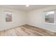 Bright bedroom with windows overlooking a quiet neighborhood and modern light-colored hard wood floors at 510 Colony Acres Dr, Charlotte, NC 28217
