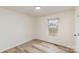 This bedroom has neutral walls and flooring, with natural light, and a view of the neighborhood at 510 Colony Acres Dr, Charlotte, NC 28217