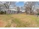 Charming gray-brick home with black shutters and a well-maintained front yard on a sunny day at 510 Colony Acres Dr, Charlotte, NC 28217