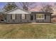 Charming gray brick home featuring a well-maintained lawn and inviting front entrance at 510 Colony Acres Dr, Charlotte, NC 28217