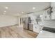 Bright, updated kitchen with stainless steel appliances, white cabinets, and a view of the deck at 510 Colony Acres Dr, Charlotte, NC 28217