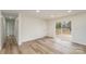 Bright living room with sliding door to deck and modern light-colored hard wood floors at 510 Colony Acres Dr, Charlotte, NC 28217