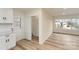 Bright living space featuring light wood flooring, closet, and large window overlooking the neighborhood at 510 Colony Acres Dr, Charlotte, NC 28217