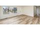 Bright living room with large window overlooking the neighborhood and modern light-colored hard wood floors at 510 Colony Acres Dr, Charlotte, NC 28217