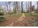 Spacious backyard featuring a stepping stone path and mature trees at 515 Culloden Ct, Charlotte, NC 28214