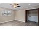 Bedroom features modern flooring, ceiling fan, a double window and a closet with bifold doors open to the utilities at 515 Culloden Ct, Charlotte, NC 28214