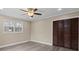 Bedroom features modern flooring, ceiling fan, a double window and a closet with bifold doors at 515 Culloden Ct, Charlotte, NC 28214
