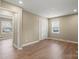 The bedroom includes modern flooring, neutral colored walls, a double window, and closet at 515 Culloden Ct, Charlotte, NC 28214