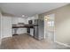 Bright kitchen featuring white cabinets, stainless steel appliances, and new floors at 515 Culloden Ct, Charlotte, NC 28214