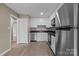 Updated kitchen with white cabinets, stainless steel appliances, and new floors at 515 Culloden Ct, Charlotte, NC 28214