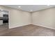 Open living room with new floors flows into the updated kitchen featuring stainless steel appliances at 515 Culloden Ct, Charlotte, NC 28214