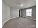 Bright carpeted bedroom featuring neutral walls, closet, and a single window at 5513 Hammermill Dr, Harrisburg, NC 28075