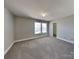 Large bedroom featuring neutral decor, carpet, and lots of natural light at 5513 Hammermill Dr, Harrisburg, NC 28075
